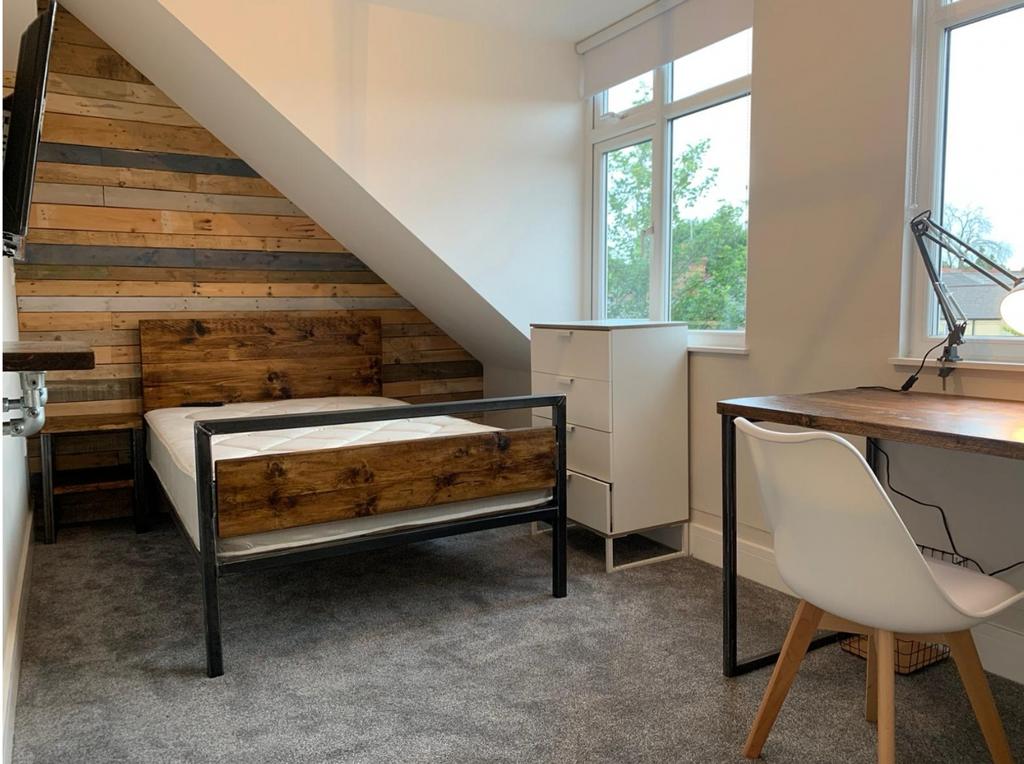 This charming double bedroom features stylish w...