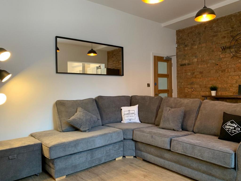 A stylish living room featuring a spacious sect...