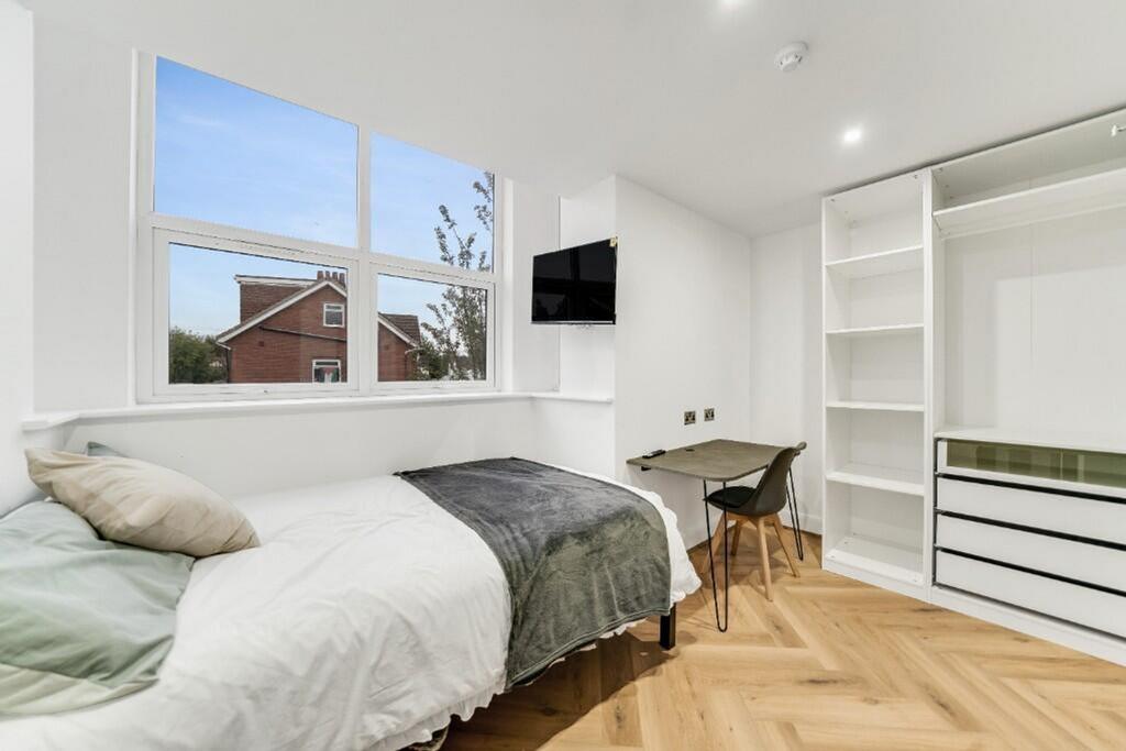 A bright and inviting double bedroom featuring ...