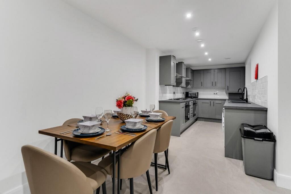 This modern kitchen features sleek cabinetry an...