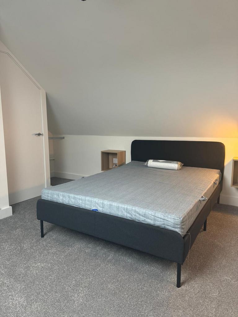 A spacious and inviting double bedroom with mod...