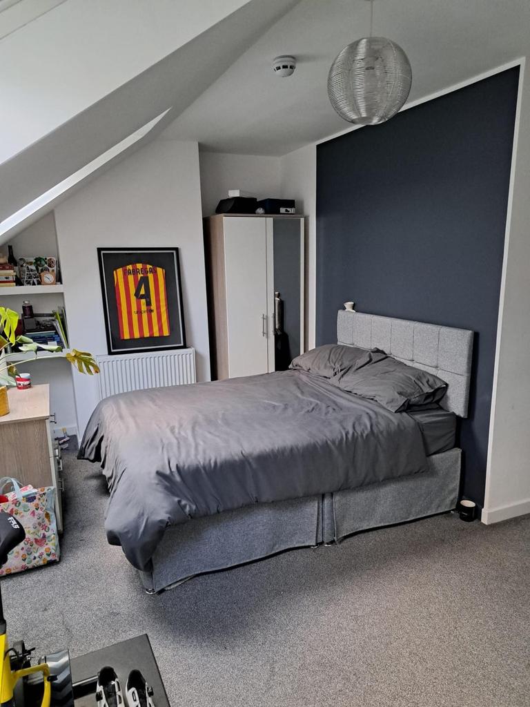 This inviting double bedroom features a comfort...