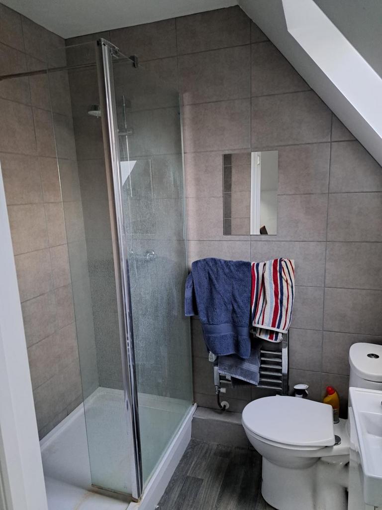 A modern bathroom featuring a sleek shower encl...