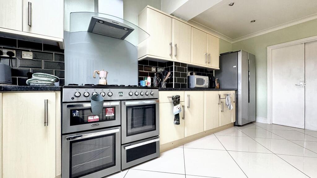 Spacious and modern kitchen featuring ample sto...