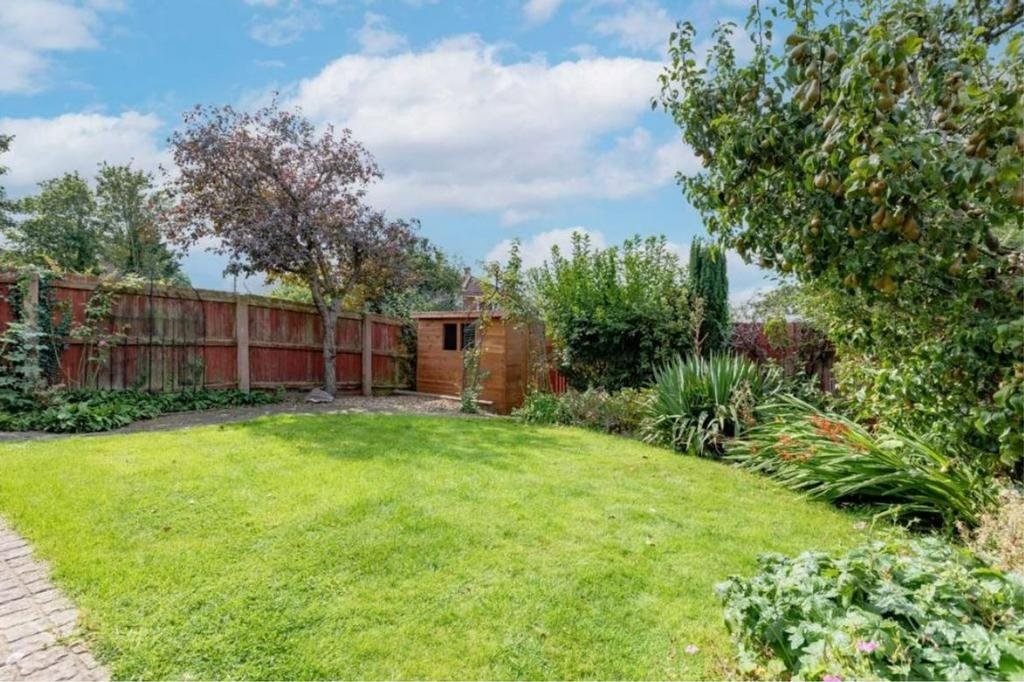 A well-maintained garden with lush green grass ...