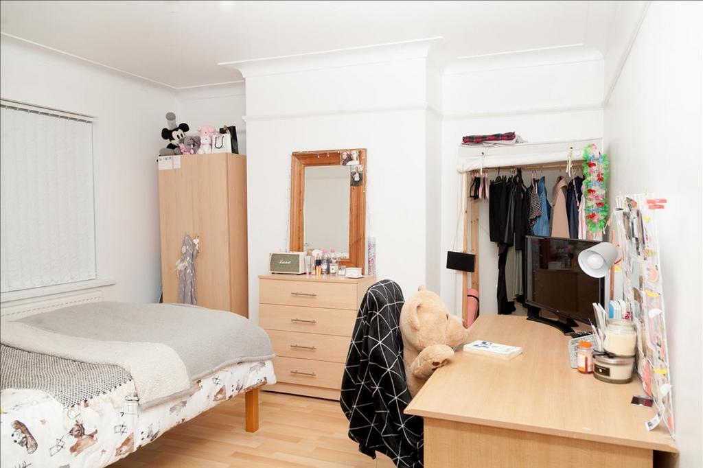 This inviting double bedroom features a comfort...