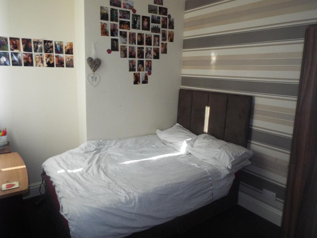 This inviting double bedroom features a cozy be...