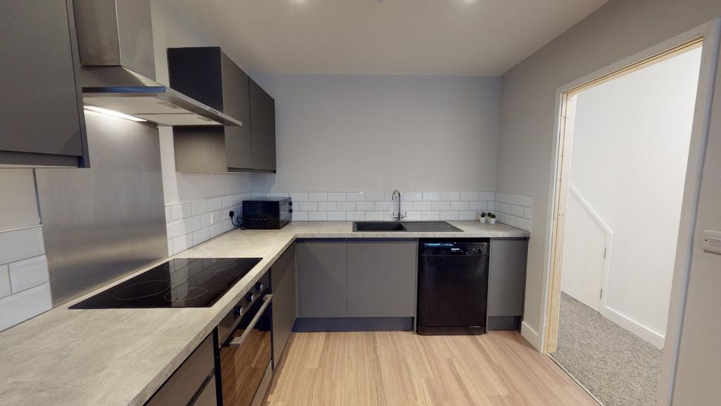 A modern and tidy kitchenette featuring sleek c...