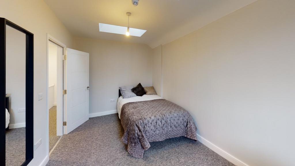 A cozy and inviting double bedroom with ample n...