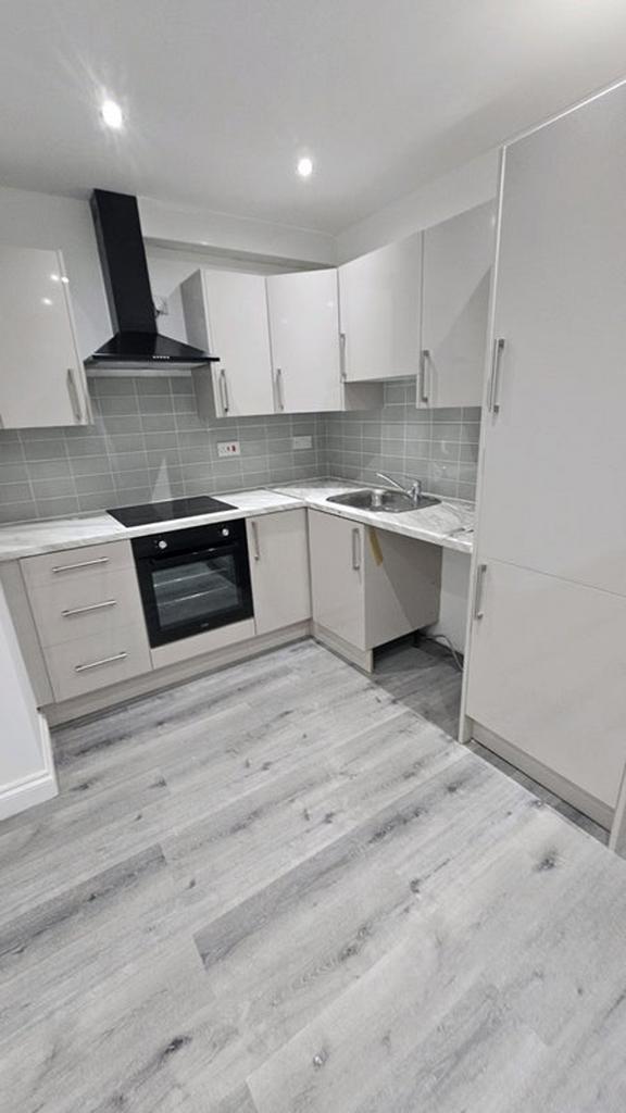 This modern kitchen features sleek cabinetry, a...