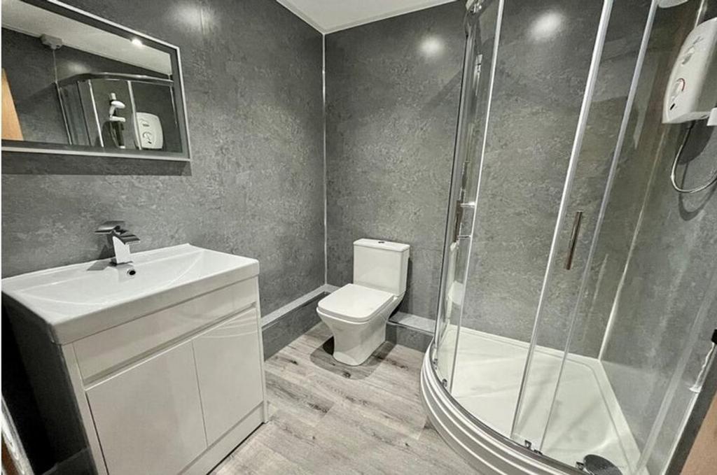 Modern bathroom suite featuring a sleek shower ...