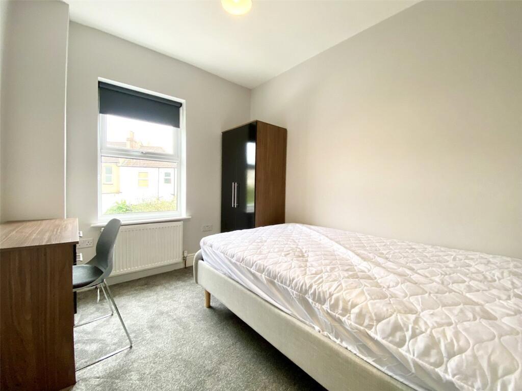 This inviting double bedroom features a cozy at...