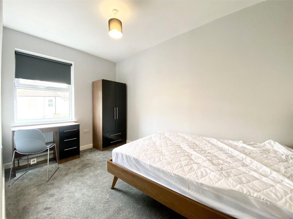 A bright and inviting double bedroom featuring ...
