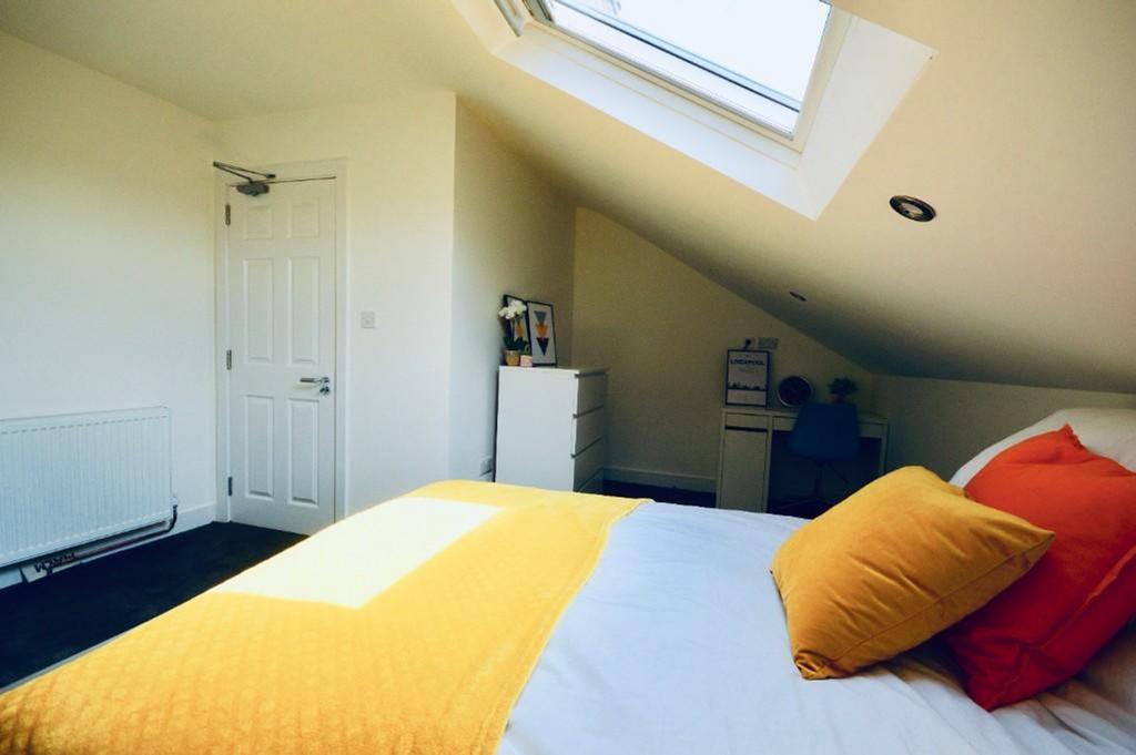 A bright and inviting double bedroom featuring ...