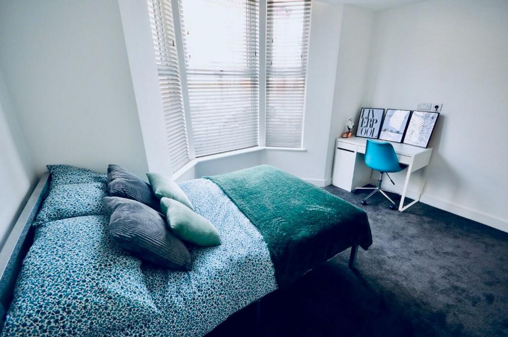 A bright and inviting double bedroom featuring ...