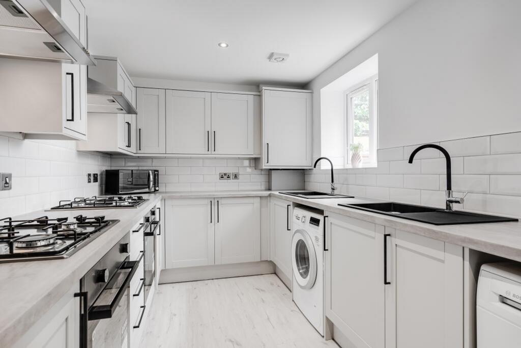 This modern kitchen features sleek cabinetry, a...