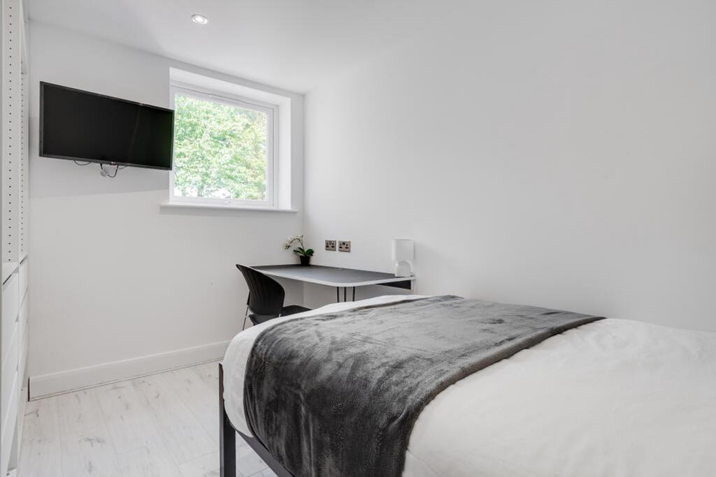Bright and modern double bedroom featuring a co...