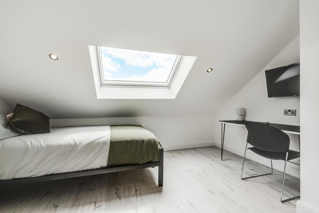 This inviting double bedroom features a cozy at...