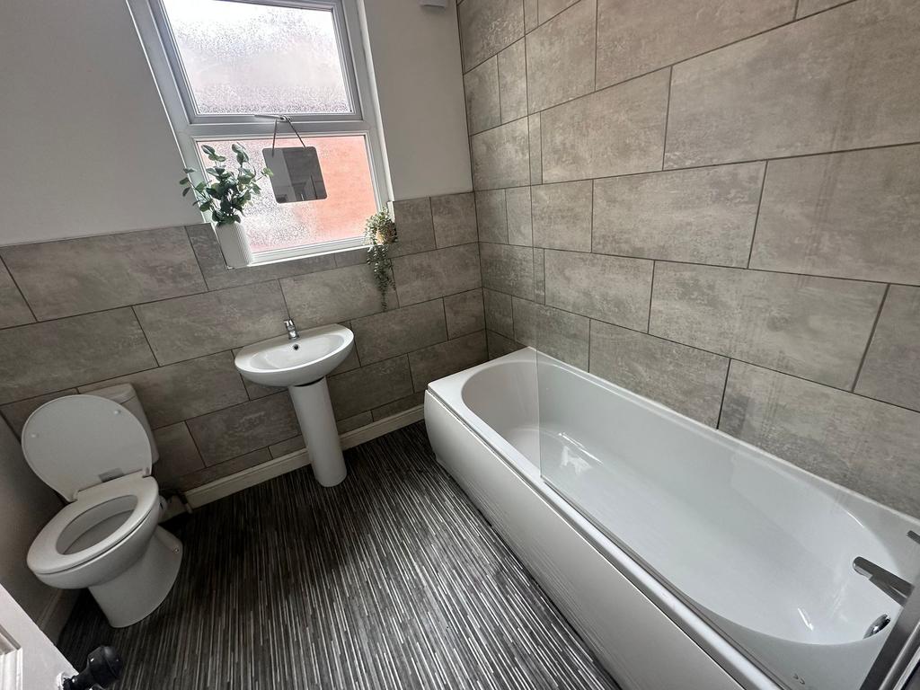 Bright and clean bathroom featuring a large bat...