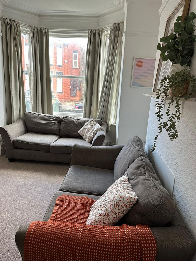 A bright and welcoming living room featuring a ...