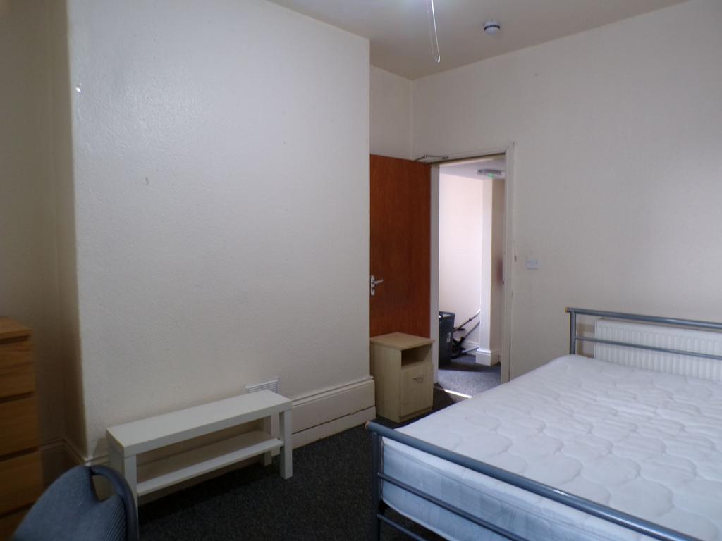 A bright and spacious bedroom featuring a doubl...