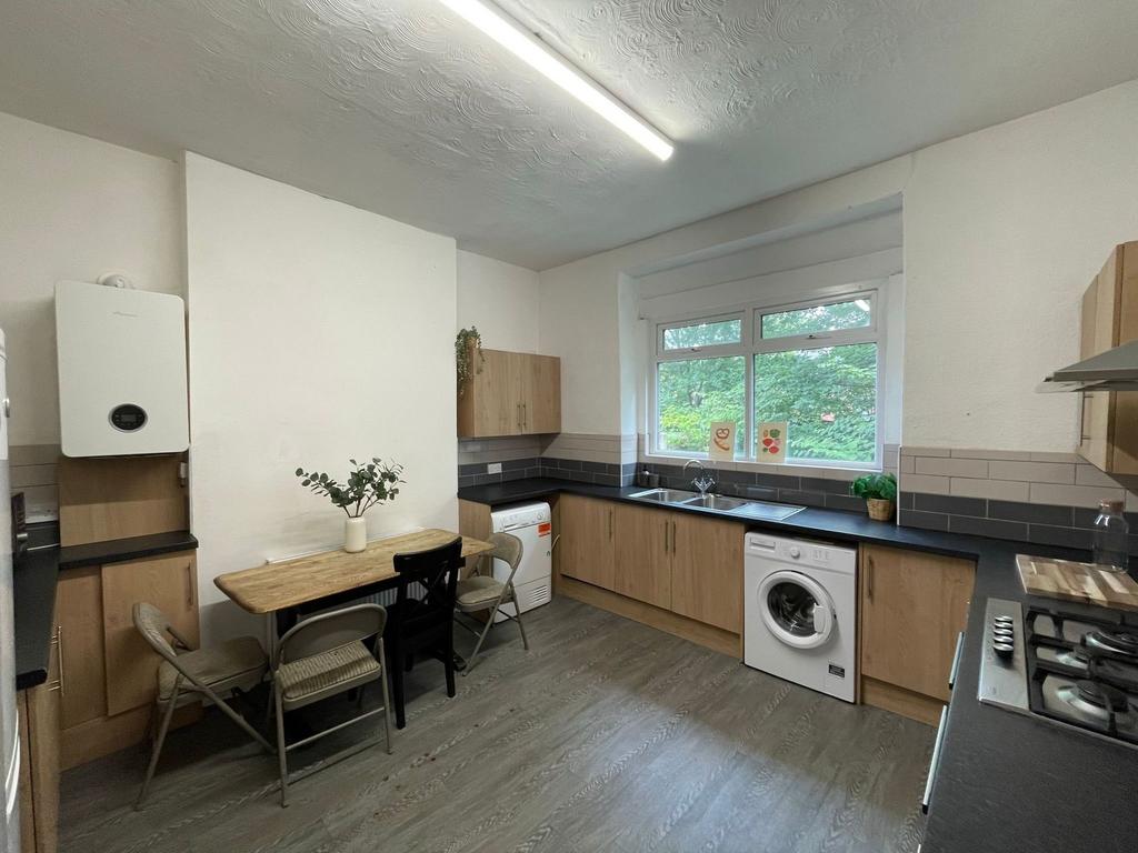 Bright and modern kitchen featuring ample natur...