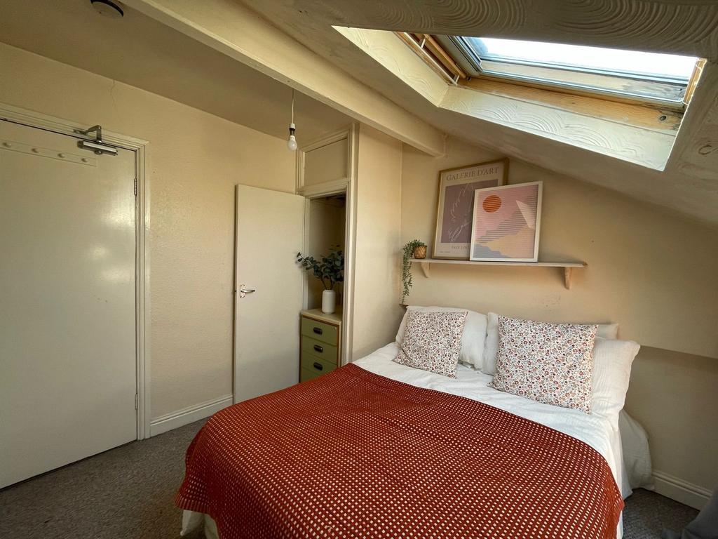 Cozy double bedroom featuring a comfortable bed...