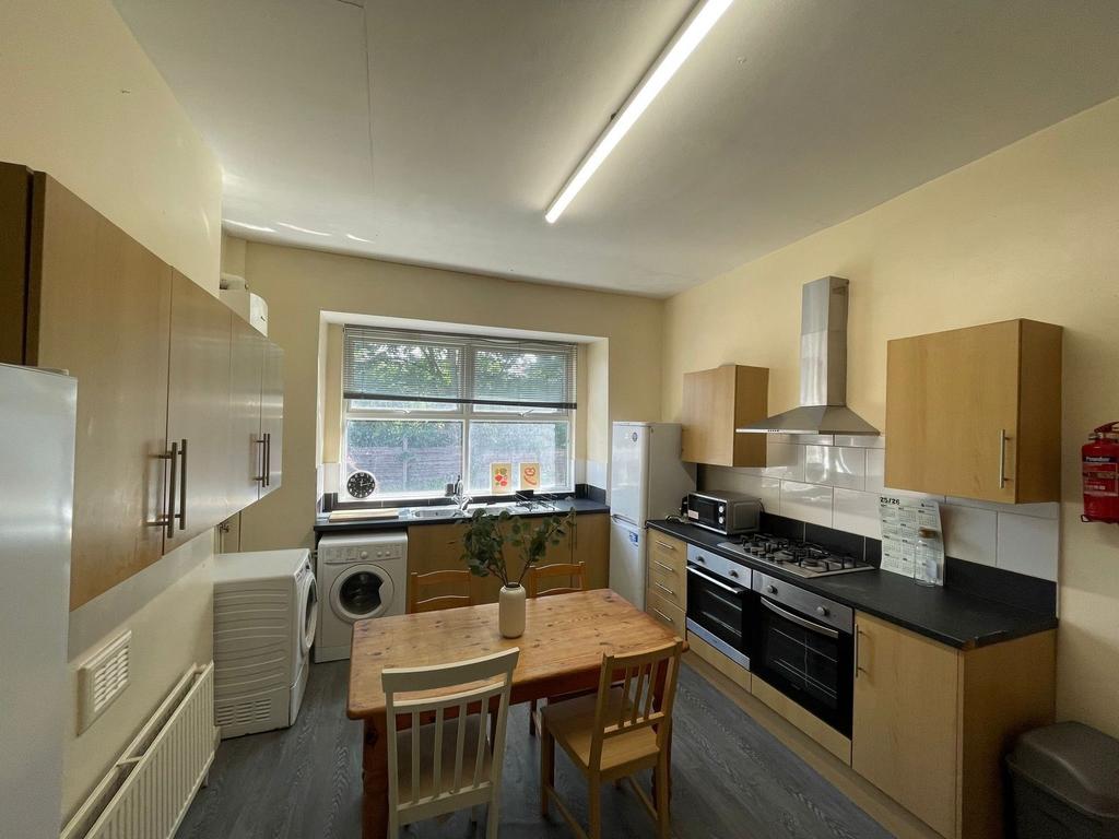 Bright and modern kitchen featuring a large win...