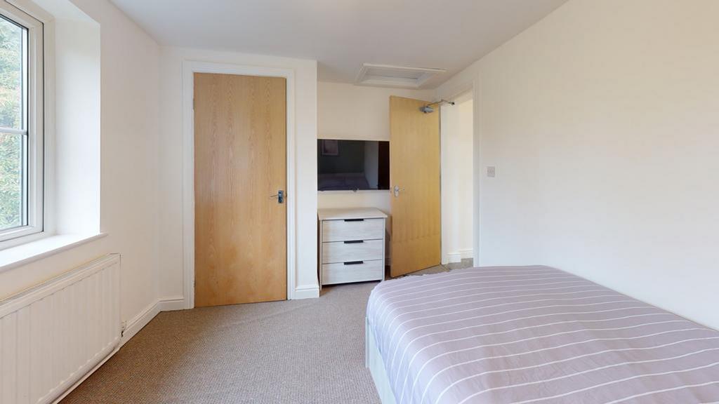 A bright and tidy double bedroom featuring ampl...