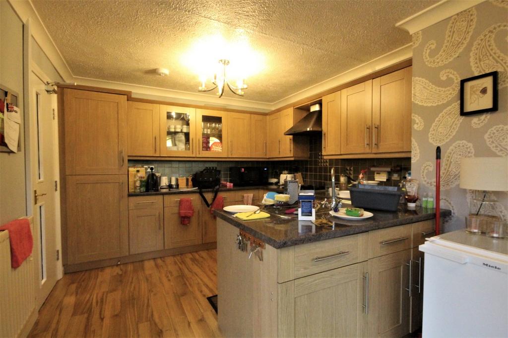 A spacious and inviting kitchen with ample stor...