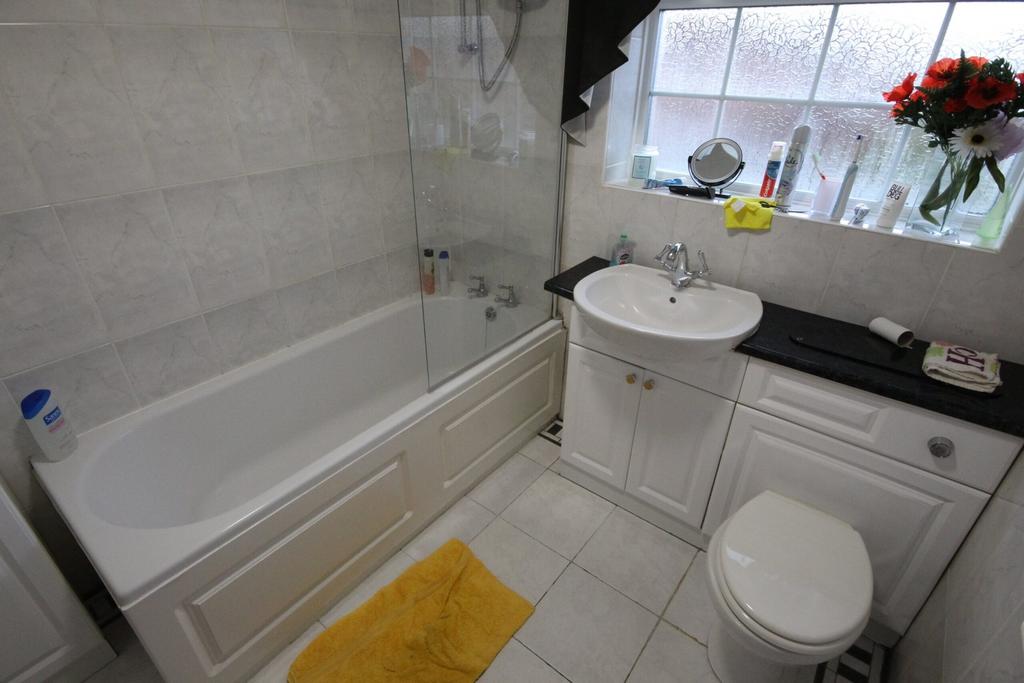 A well-maintained bathroom featuring a bathtub ...