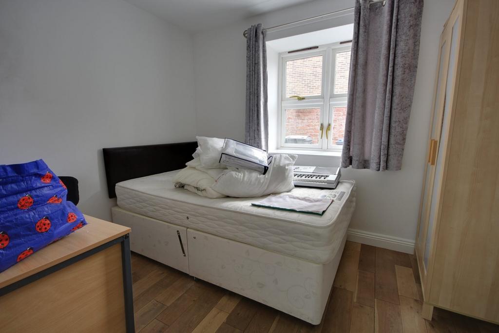 A cozy double bedroom with ample natural light ...