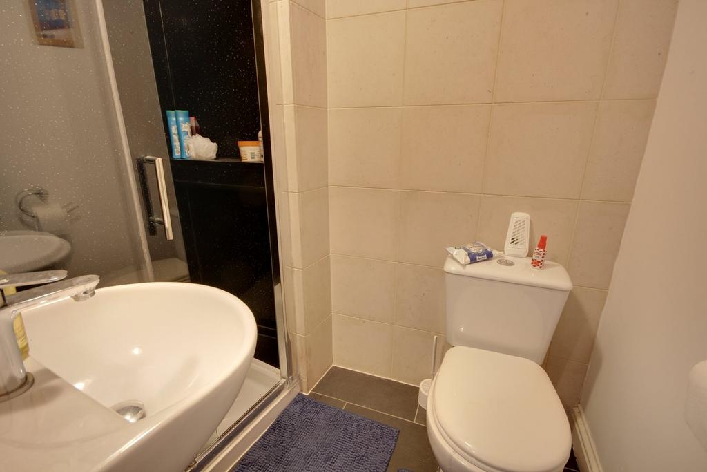 A modern bathroom featuring a shower and stylis...