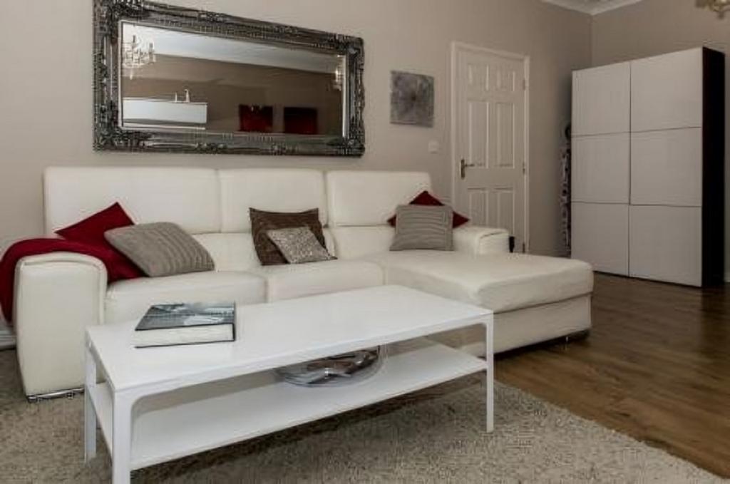 A stylish and spacious modern living room, perf...