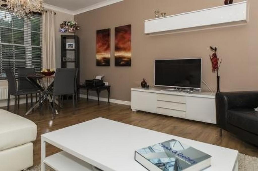A spacious and modern living room featuring sty...
