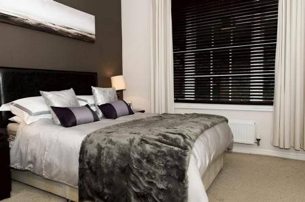A stylish and inviting double bedroom featuring...