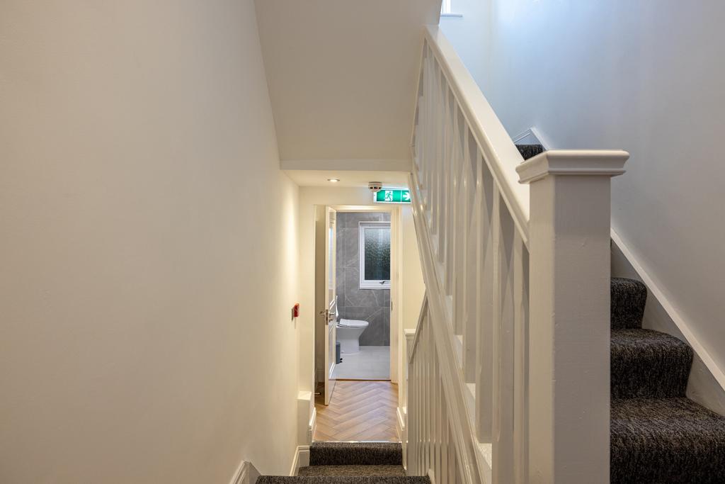 A well-maintained staircase leading to a bright...