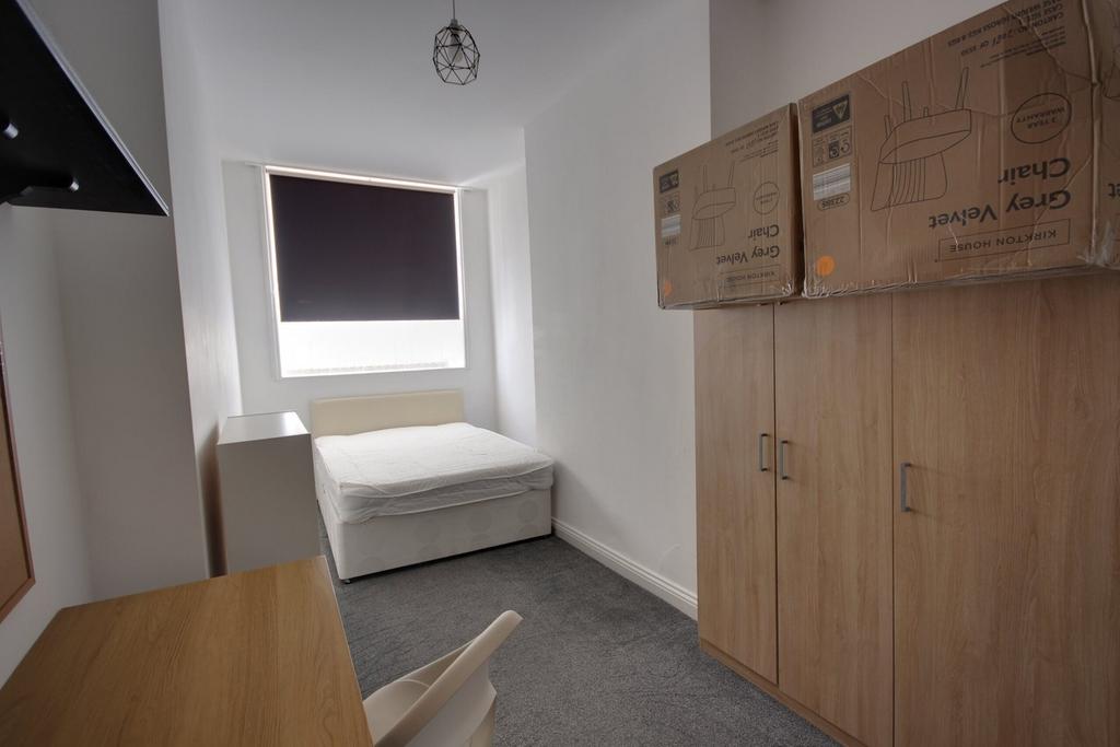 A bright and tidy double bedroom featuring a co...