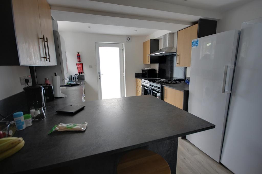 A bright and modern kitchen with ample storage ...