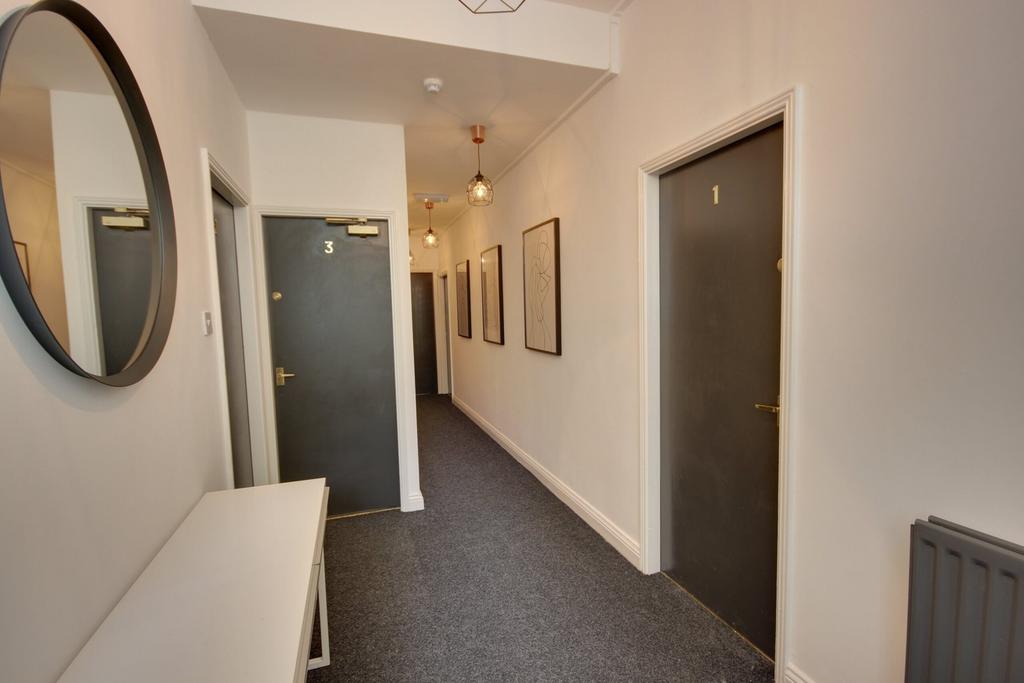 A bright and tidy hallway with modern decor, pe...