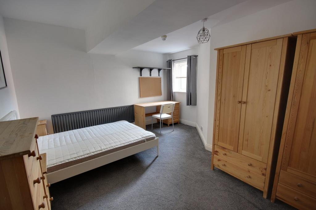 A bright and spacious double bedroom featuring ...