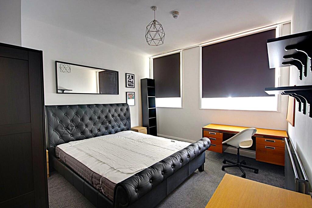A spacious and well-lit double bedroom featurin...