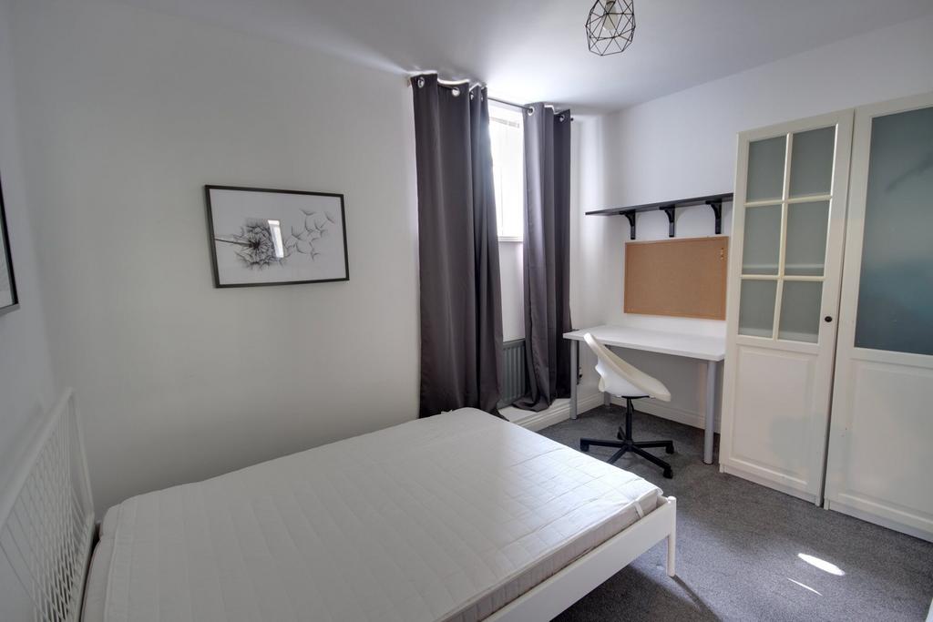 A bright and inviting double bedroom featuring ...