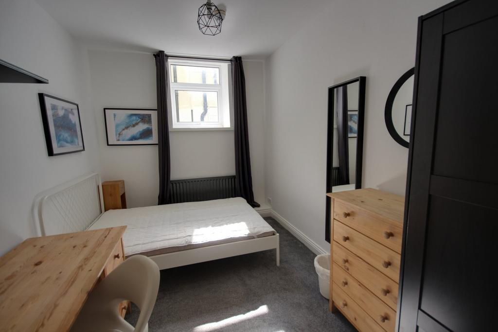 A bright and inviting double bedroom with moder...