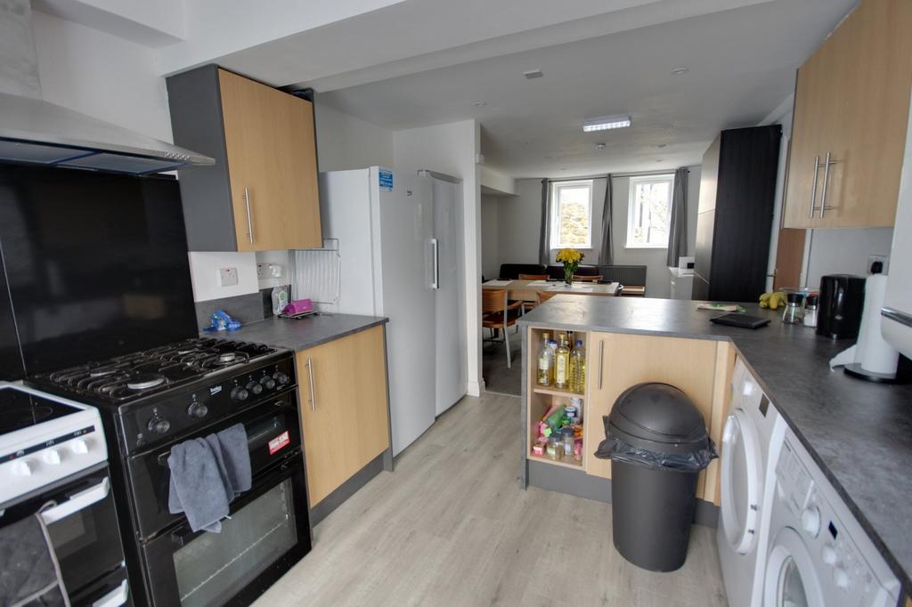 A spacious and modern kitchen featuring ample s...