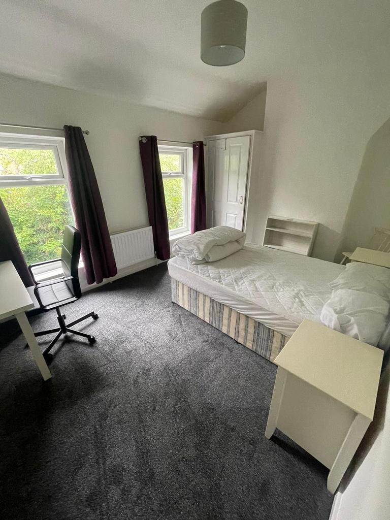 A bright and spacious double bedroom featuring ...