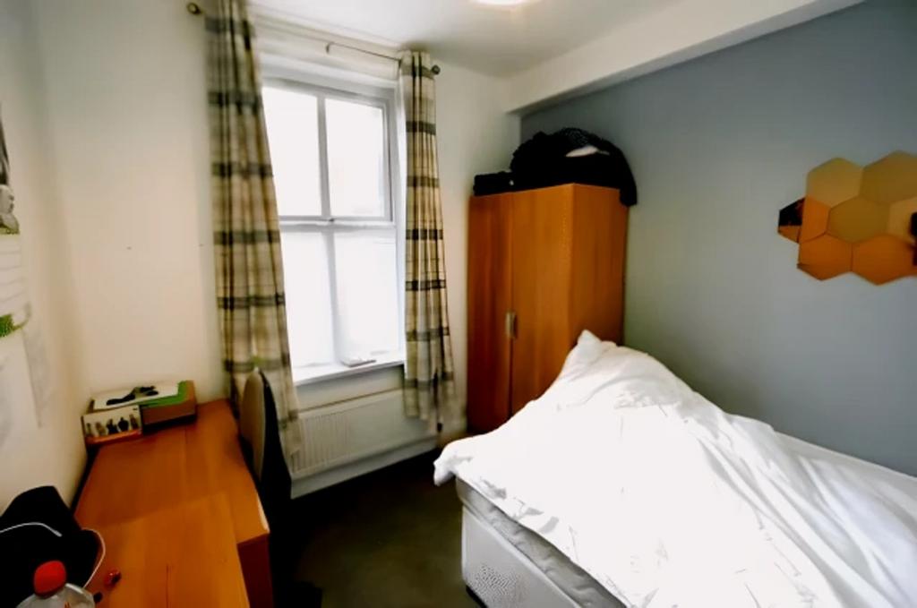 A cozy and well-lit double bedroom, perfect for...