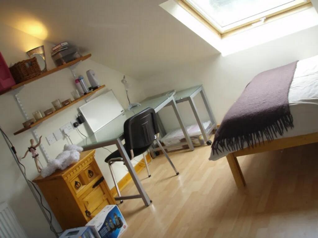 This charming double bedroom features a cozy la...