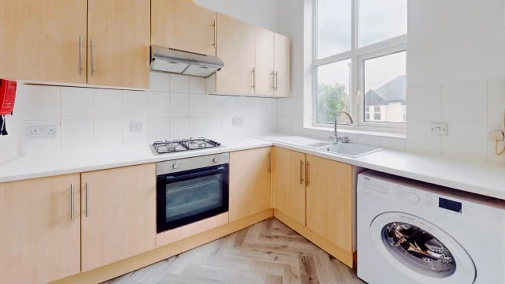 A bright and modern kitchenette equipped with e...