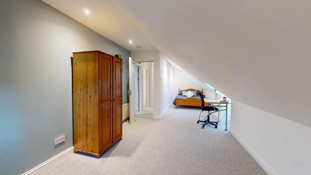 A spacious and inviting double bedroom featurin...